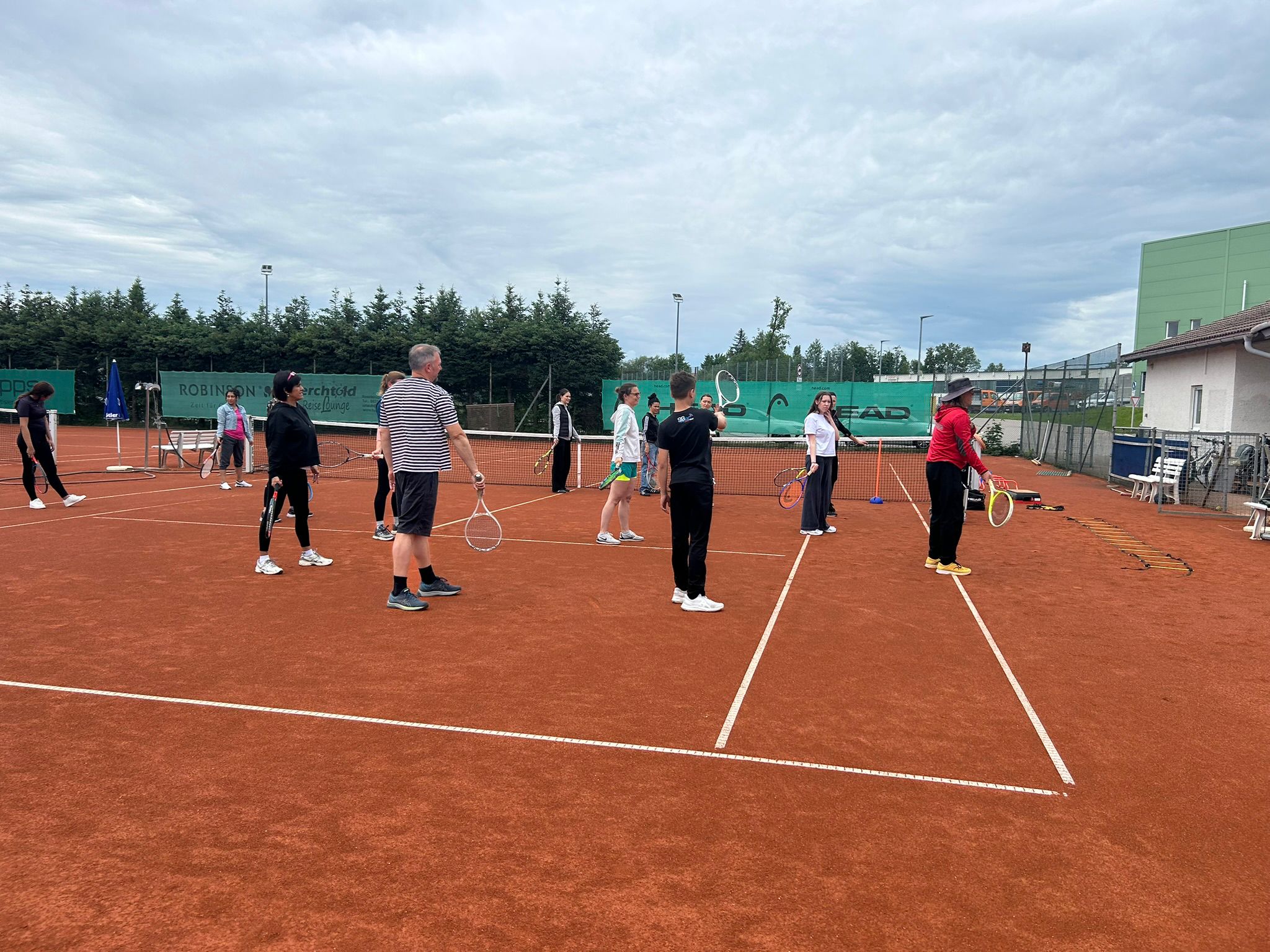 Gruppe beim Tennis Anfängerkurs Kempten – Aufwärmübung auf dem Sandplatz TSV Kottern